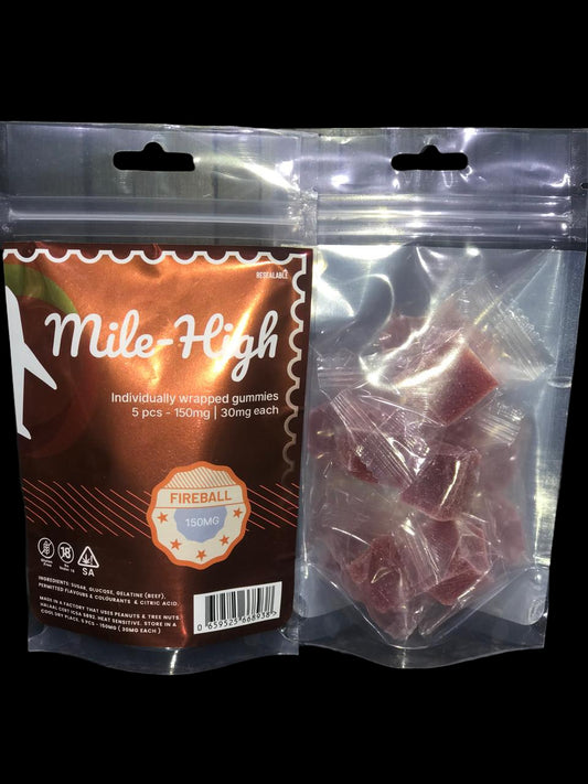 Mile High Fireball gummies packaging with gummies inside a clear bag on a dark surface.